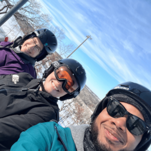 Geoffrey, Kaylie and Sheila on the Ski Lift posing for a picture. 